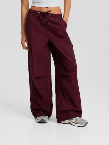 Bershka Wide leg Cargo trousers in Red: front