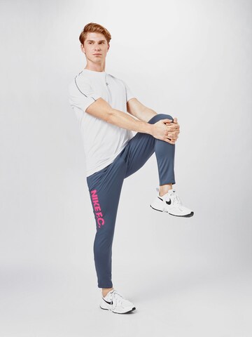 NIKE Slim fit Workout Pants in Blue