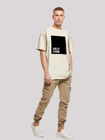 T-Shirt 'SELF CARE' F4NT4STIC en beige