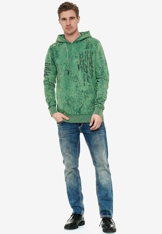 Rusty Neal Sweatshirt in verwaschenem Look mit Schriftzug in Grün