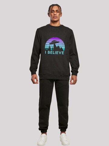 Sweat-shirt 'I BELIEVE UFO Alien Raumschiff Retro' F4NT4STIC en noir