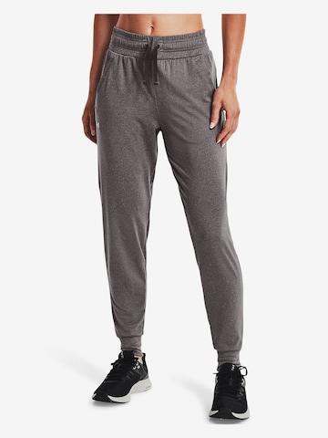 Effilé Pantalon de sport UNDER ARMOUR en gris : devant