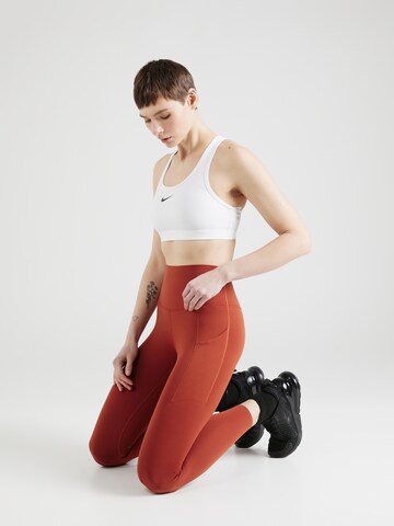 Skinny Pantaloni sportivi 'UNIVERSA' di NIKE in arancione