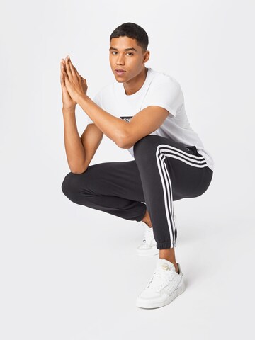 ADIDAS SPORTSWEAR Alt kitsenev Spordipüksid 'Essentials French Terry Tapered 3-Stripes', värv must