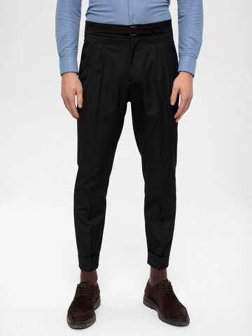 Antioch Tapered Pleat-Front Pants in Black: front