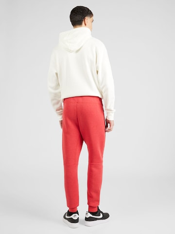 Nike Sportswear Tapered Παντελόνι 'TECH FLEECE' σε κόκκινο