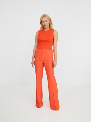 ABOUT YOU x Iconic by Tatiana Kucharova Flared Pants 'Jillian' in Orange