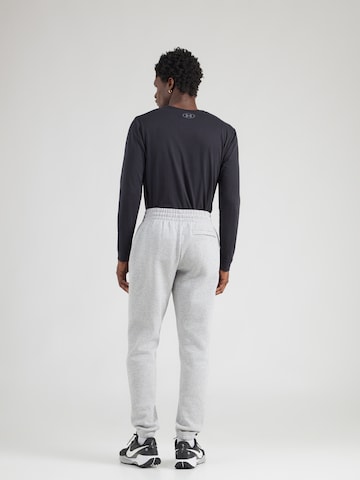 UNDER ARMOUR Tapered Urheiluhousut 'Essential' värissä harmaa