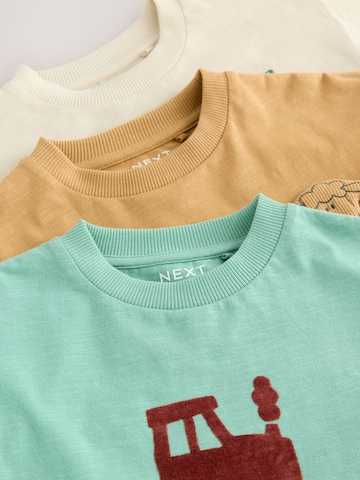 Tricou de la Next pe bej