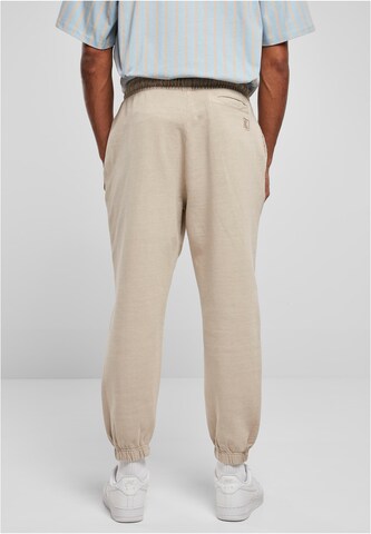 Karl Kani - Tapered Pantalón en beige