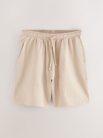 Next Pyjamahousut värissä beige
