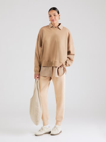 Tapered Pantaloni di GUESS in beige