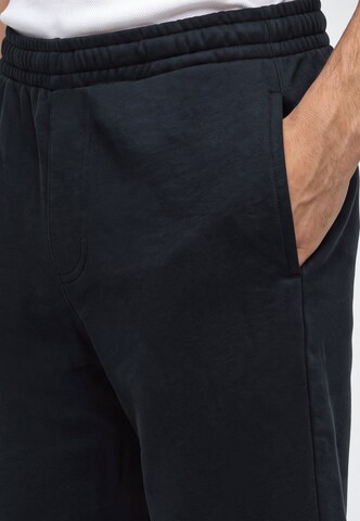 Karl Kani - regular Pantalón 'Signature' en negro