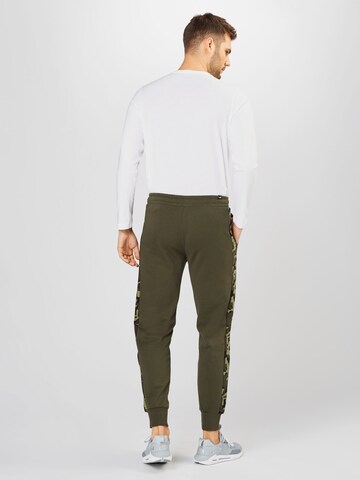 Tapered Pantaloni sport de la PUMA pe verde