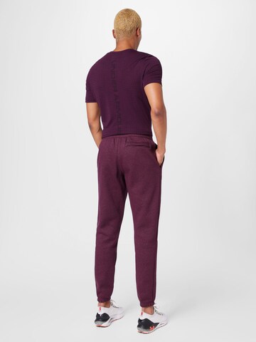 UNDER ARMOUR - Tapered Calças de desporto 'Essential' em vermelho