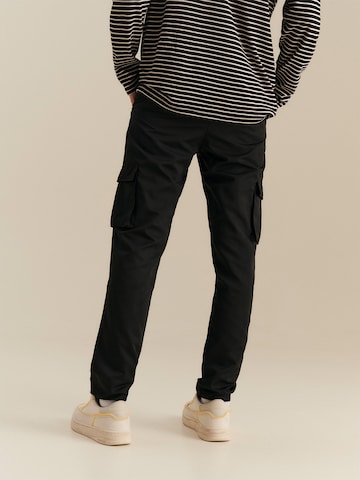 About You x Nils Kuesel Tapered Pants 'Iven' in Black