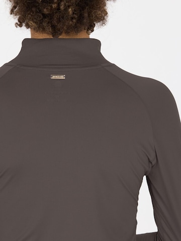 Athlecia Functioneel shirt 'Grina' in Bruin