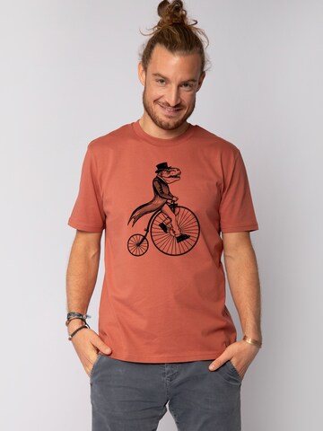 Watapparel Shirt 'T-Rex auf Fahrrad' in Orange: front