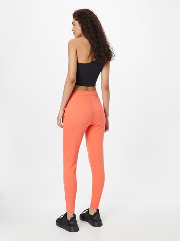 Effilé Pantalon de sport 'Rival' UNDER ARMOUR en orange