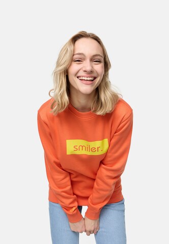 Sweat-shirt smiler. en orange