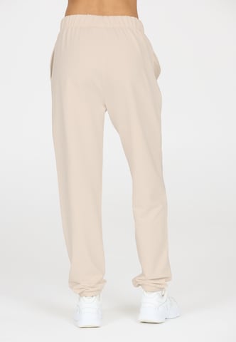 Athlecia Regular Sports trousers in Beige