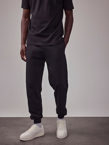 DAN FOX APPAREL Tapered Pants 'The Essential' in Black: front