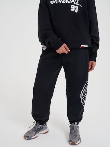 AND1 Tapered Funktionsbyxa i svart: framsida