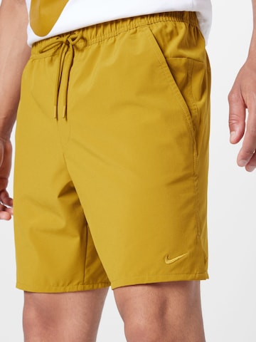 NIKE Regular Workout Pants 'Unlimited' in Yellow