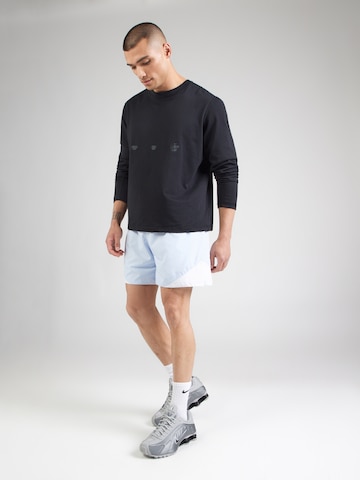 Largi Pantaloni 'WR' de la Nike Sportswear pe albastru