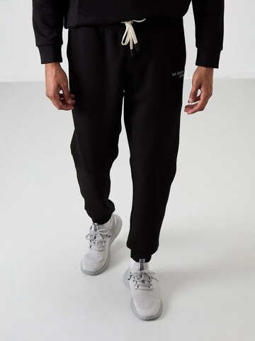 Tommy Life Trainingspak 'Aktive Sets' in Zwart