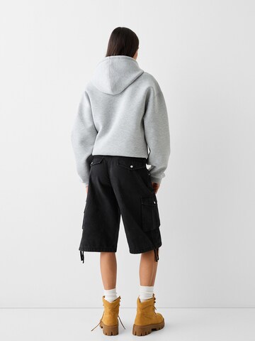 Bershka Zvonové kalhoty Kapsáče – černá