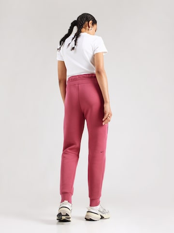 Nike Sportswear Tapered Nadrág 'TCH FLC' - rózsaszín