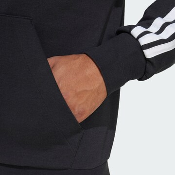 ADIDAS SPORTSWEAR Urheilullinen collegetakki 'Essentials' värissä musta