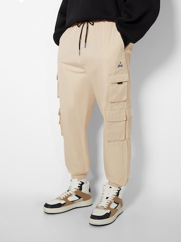 Bershka Tapered Cargo trousers in Beige