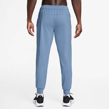 NIKE Tapered Workout Pants in Blue