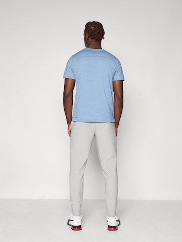 PUMA Конический (Tapered) Спортивные штаны 'Cloudspun' в Серый: сзади