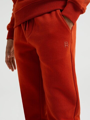 WE Fashion Zúžený Kalhoty – oranžová