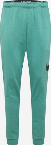 NIKE Tapered Sports trousers in Green: front