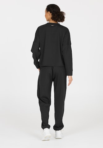 Athlecia Regular Sports trousers in Black