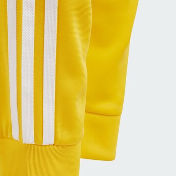 ADIDAS ORIGINALS Tapered Pants 'Adicolor SST' in Yellow