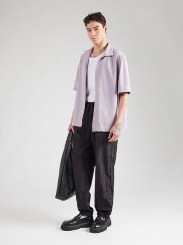 Tapered Pantaloni di Versace Jeans Couture in nero