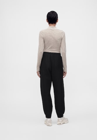 Nike Sportswear - Tapered Pantalón 'Studio' en negro
