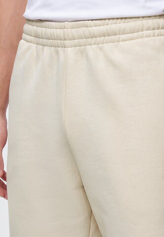 Regular Pantaloni de la Karl Kani pe bej