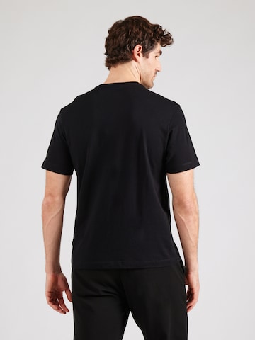 Maglietta di GUESS JEANS in nero