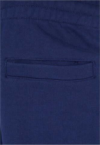 Tapered Pantaloni di Urban Classics in blu
