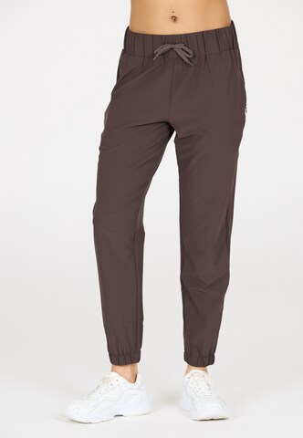 Athlecia Tapered Sports trousers 'Austberg' in Brown: front