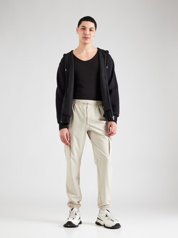 UNDER ARMOUR Tapered Sports trousers 'Vibe' in Beige