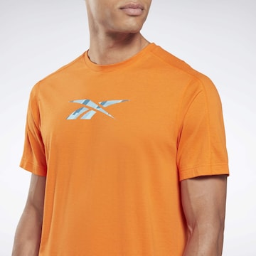 Reebok - Camisa funcionais em laranja