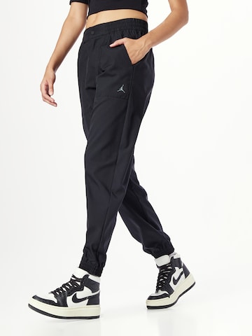 Jordan Tapered Trousers in Black: front