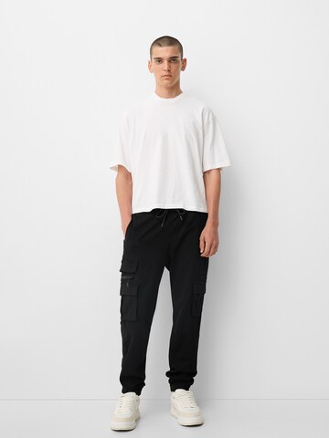 Bershka Tapered Cargo trousers in Black